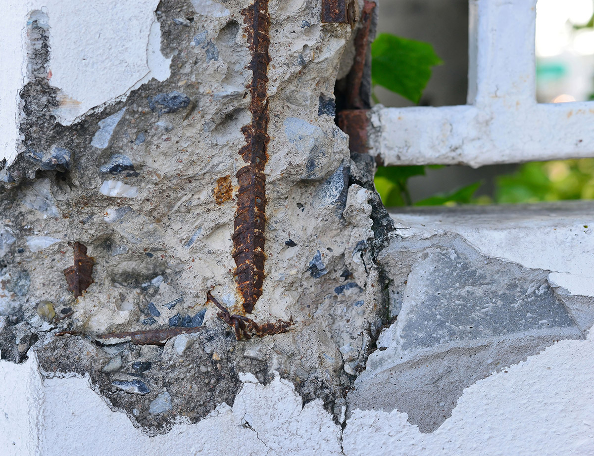 Concrete with exposed rusted steel